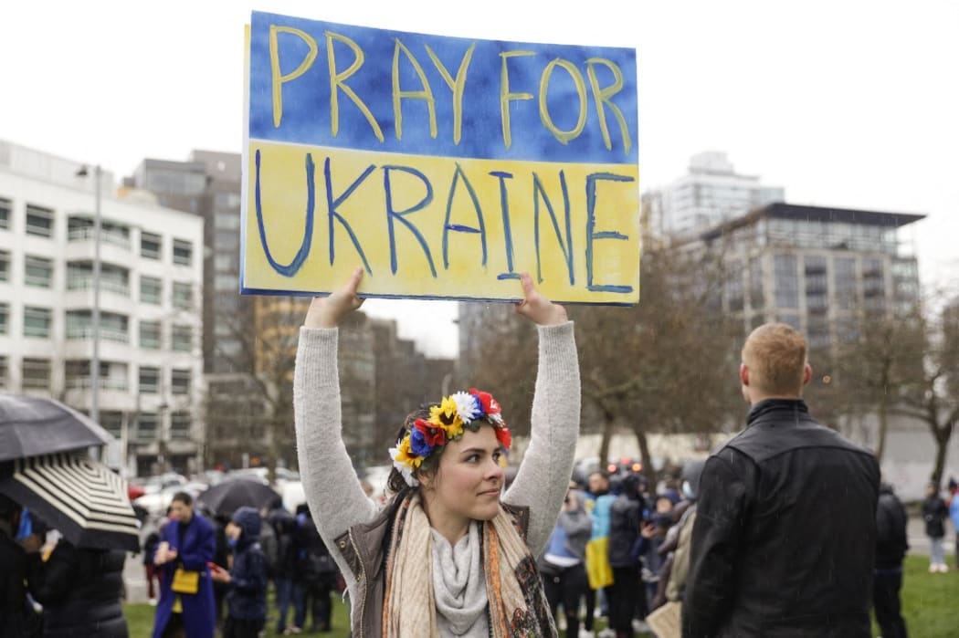 Oksana Zelanik, of Seattle and born in Ukraine, holds a "pray for Ukraine sign" during a "Rally Against the War With Ukraine" event in Seattle, Washington on February 26, 2022.