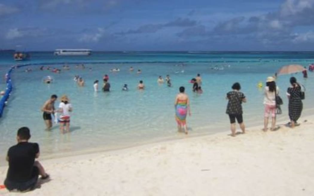 Asian tourists on a CNMI beach