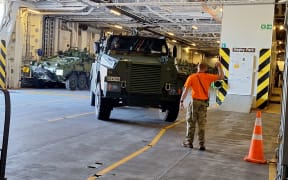 A new Bushmaster being driven on to the HMNZS Canterbury in Wellington on Thursday 5 June, 2025, headed for the Talisman Sabre military exercise.