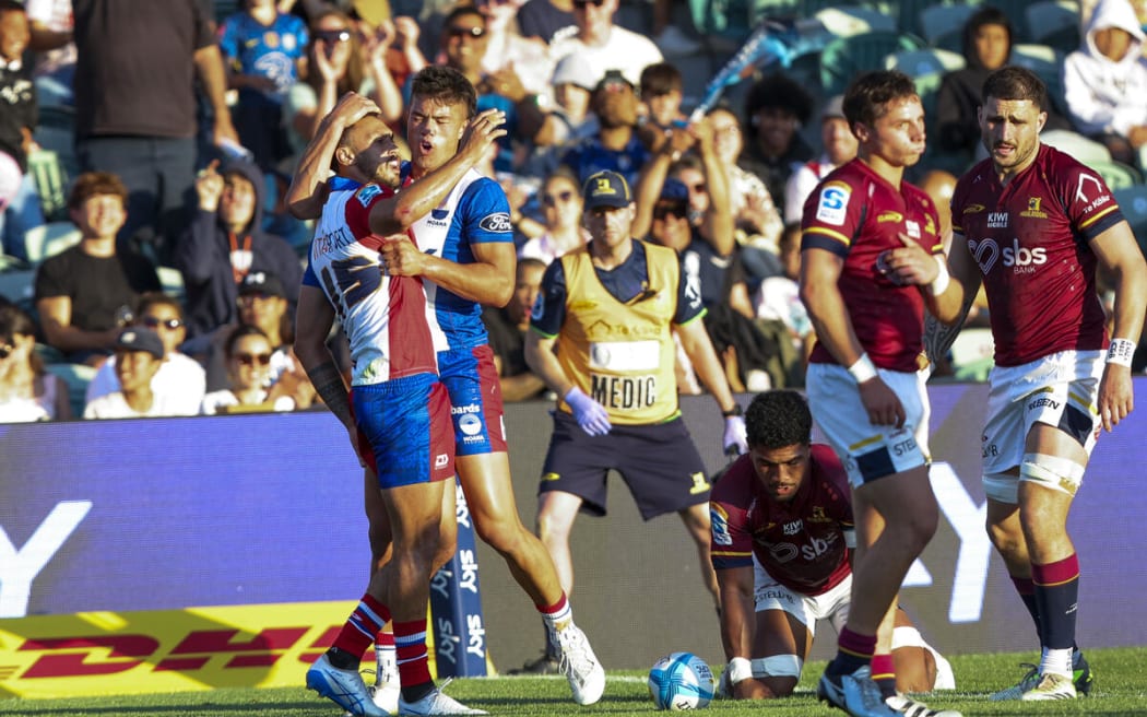 Moana Pasifika's William Havili celebrates a try with teammate Kyren Taumoefolau.