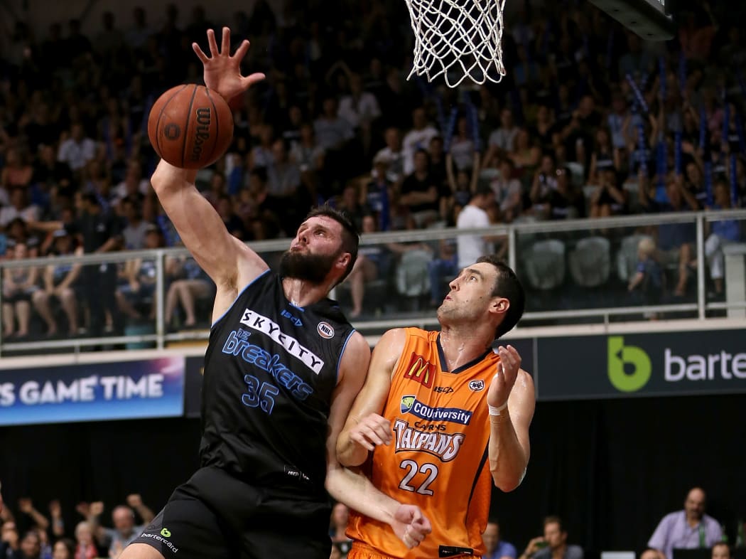 Breakers' Alex Pledger beats Taipans' Matthew Burston to score.