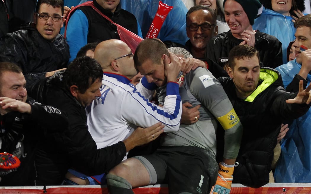Serbian fans celebrate with their goalkeeper and Golden Glove winner Slobodan Rajkovic