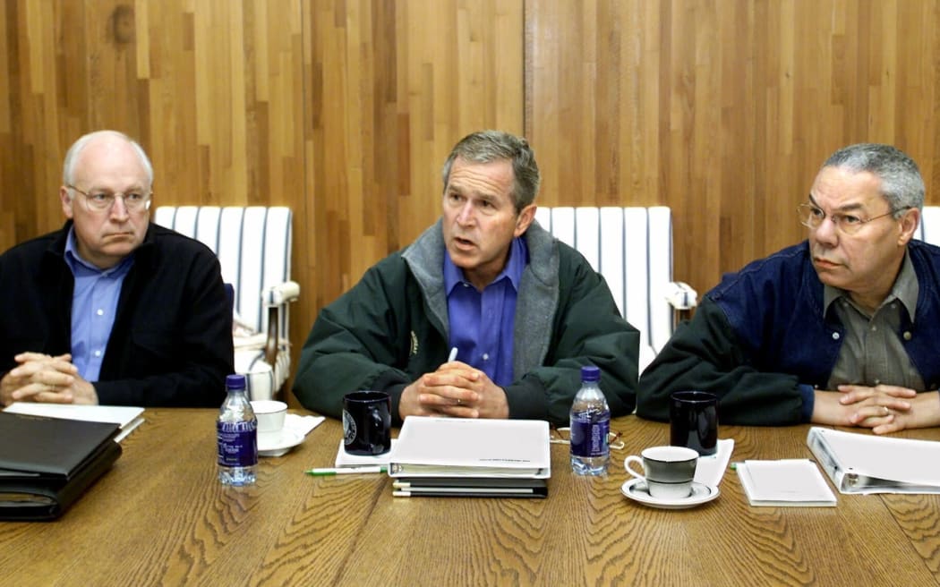 Cheney sits next to President George W Bush as he meets with his cabinet and advisers, including Secretary of State Colin Powell, in September 2001, at Camp David in Maryland.
