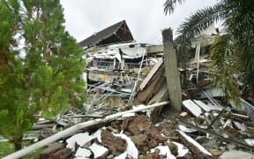 A general view shows a collapsed building in Mamuju