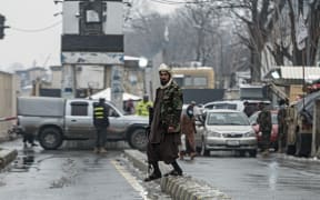 A member of Taliban security force stands guard on a blocked road after a suicide blast near Afghanistan's foreign ministry at the Zanbaq Square in Kabul on January 11, 2023. - A suicide bomber detonated a device on January 11 near Afghanistan's foreign ministry in the capital, causing more than 20 causalities, an AFP staff member said. (Photo by Wakil KOHSAR / AFP)