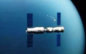 This TV grab taken on 2 November 2011 shows an animated video clip of the docking of the Tiangong-1 space lab module and the Shenzhou VIII (Shenzhou-8) spacecraft in space.