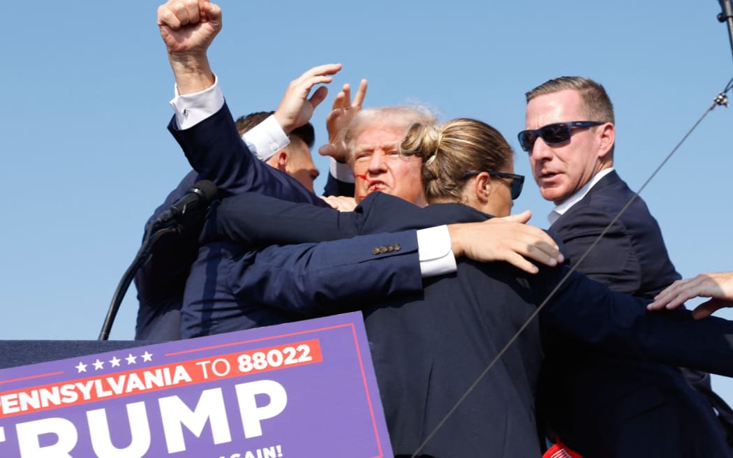 BUTLER, PENNSYLVANIA - JULY 13: Republican presidential candidate former President Donald Trump is rushed offstage during a rally on July 13, 2024 in Butler, Pennsylvania.   Anna Moneymaker/Getty Images/AFP (Photo by Anna Moneymaker / GETTY IMAGES NORTH AMERICA / Getty Images via AFP)