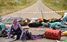 Environmental campaigners holding a protest against the development of the India-backed Adani coal mine.