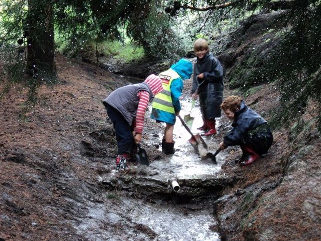 Children playing in a stream