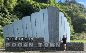 General Manager of Brewtown, Phil Gorman with the recently boganised Upper Hutt sign.