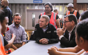 Prime Minister Chris Hipkins, centre, Emergency Management Minister Kieran McAnulty, left, and Finance Minister Grant Robertson at the Moana Nui A Kiwa Hub, for the south Auckland response to the flooding, in Māngere, 1 Febraury 2023.