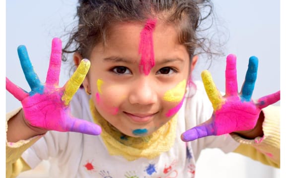 little girl covered in paint