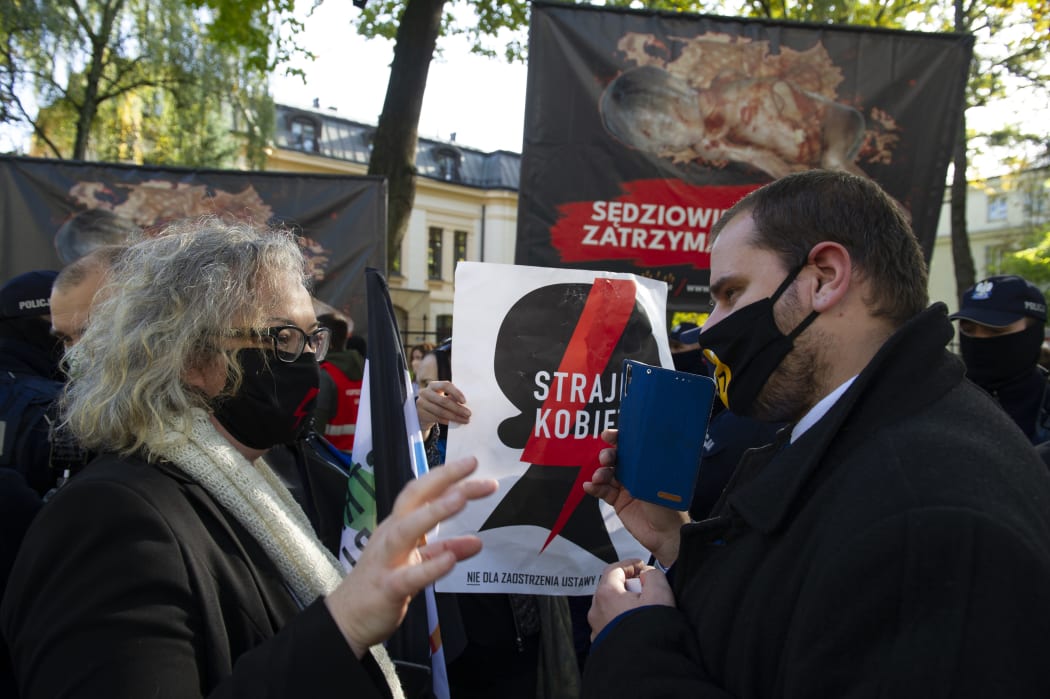 Woman's rights activist and co-founder of All-Poland's Women Strike, Marta Lempart (left) argues with a pro-life supporter as a protest and counter-protest took place prior to the Polish Constitutional Tribunal issuing its decision on abortion.
