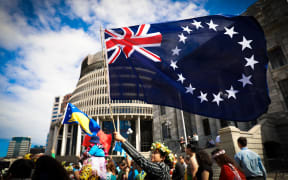 The Cook Islands flag is waved outside Parliament during the strike for climate change in Wellington September 2019