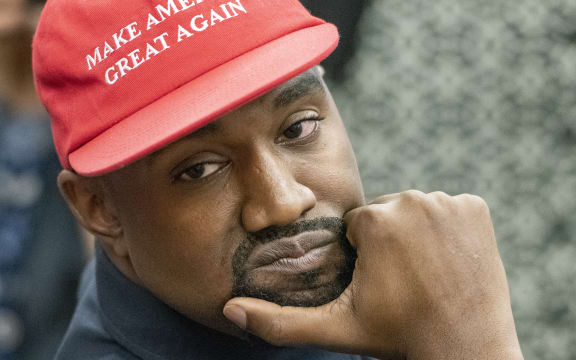 Kanye West listens as he as he and Jim Brown meet with United States President Donald J. Trump in the Oval Office of the White House in Washington, DC on Thursday, October 11