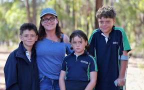 Austin (right) with his brother Beau, mother Joanne and sister Grace (left to right).