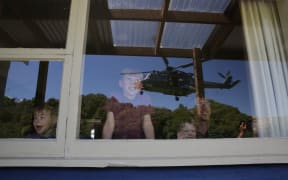 A Defence helicopter nears the home of a Kaikoura Family
