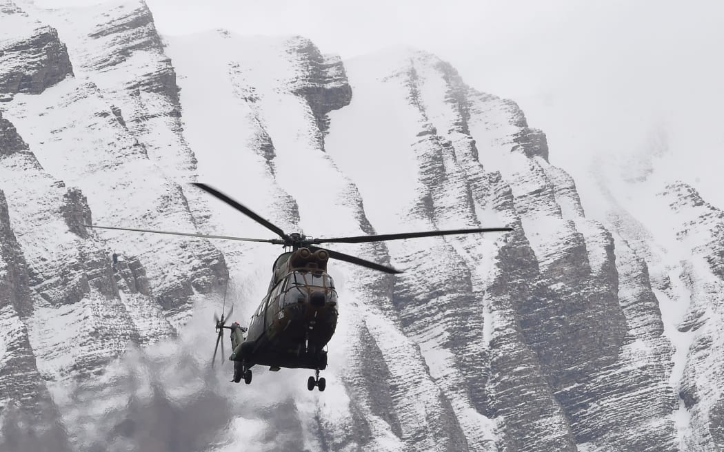 A helicopter flies near Seyne, south-eastern France, near the site where the Airbus A320 crashed in the French Alps.