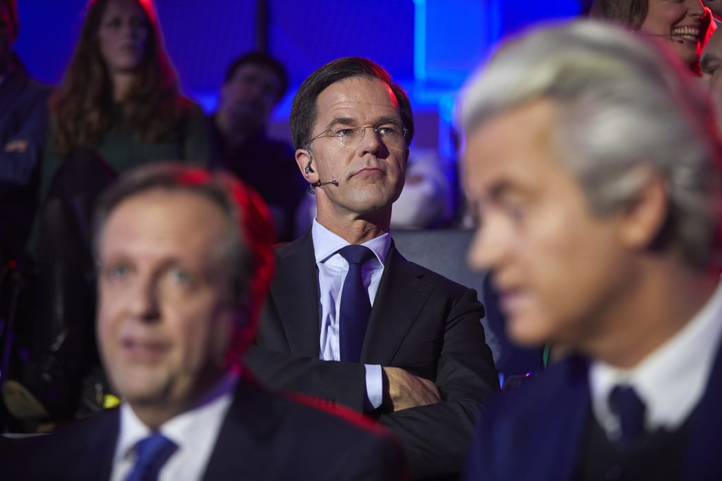 Netherland's Prime Minister Mark Rutte sits behind Alexander Pechtold of Dutch Democratic 66, left, and eert Wilders of the Freedom Party, right, ahead of a televised election debate.