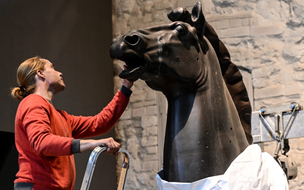 14 October 2022, Berlin: One of the Thorak horses is unpacked by restorer Franz Mahler at the Spandau Citadel. The sculptures "Striding Horses" by the sculptor Josef Thorak will be shown in the exhibition rooms of the Stadtgeschichtliche Museen Spandau in the future. Thorak was one of Adolf Hitler's favorite artists and had been commissioned to create the horses as garden ornaments for the New Reich Chancellery in Berlin-Mitte. Photo: Britta Pedersen/dpa (Photo by BRITTA PEDERSEN / DPA / dpa Picture-Alliance via AFP)