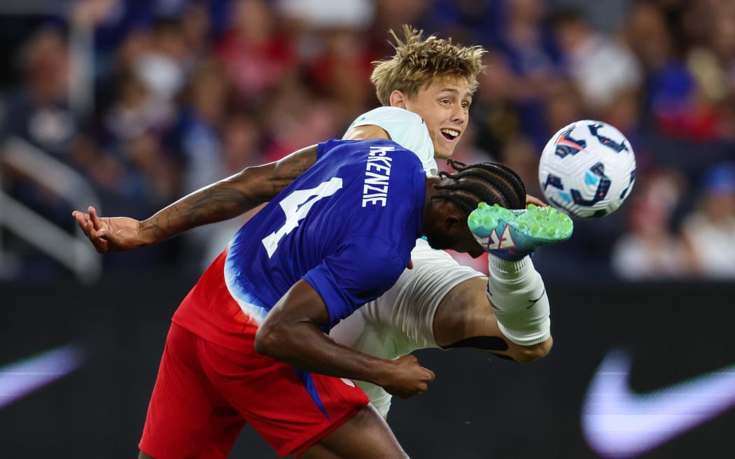 All Whites goal scorer Ben Waine battles for the ball with Mark McKenzie of USA.