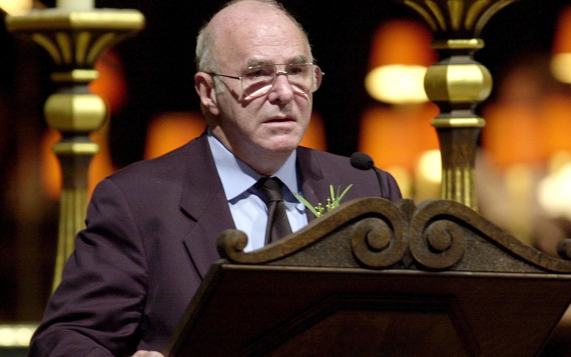 Australian TV host Clive James reads during a remembrance service for the Bali bombing victims at Saint Paul's Cathedral in central London 25 October 2002. (Photo by RICHARD LEWIS / AP WPA ROTA POOL / AFP)