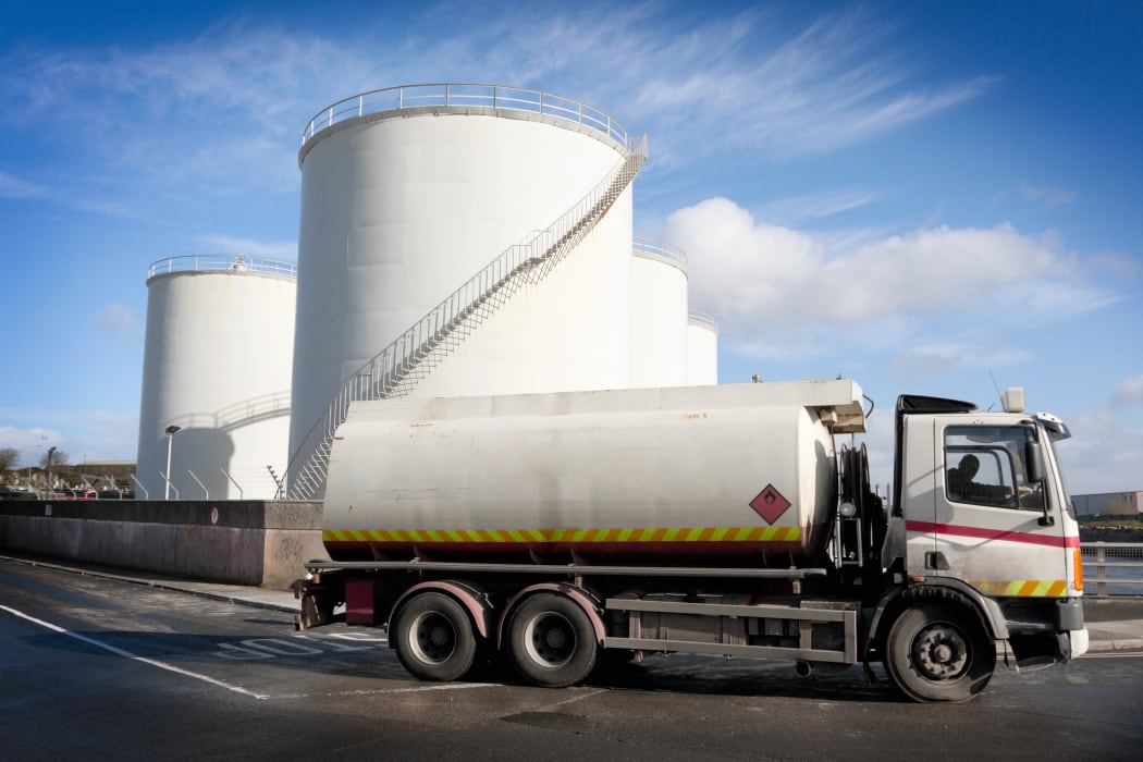 A truck with a fuel tank at an industrial storage site.