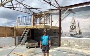 “Handy Andy” Handyman Andy Brown helping board up Bruce Howley’s shed. The mural on the wall has remained, but the roof hasn’t.