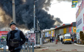 Black smoke rises into the sky from the Barabashovo market - one of the largest markets in the eastern Europe covering an area of more than 75 hectares -  which was reportedly hit by shelling, in Kharkiv on March 17, 2022, amid the ongoing Russia's invasion of Ukraine.