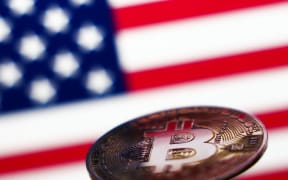 American flag displayed on a laptop screen and representation of Bitcoin cryptocurrency are seen in this illustration photo taken in Krakow, Poland on November 6, 2024. (Photo by Jakub Porzycki/NurPhoto) (Photo by Jakub Porzycki / NurPhoto / NurPhoto via AFP)