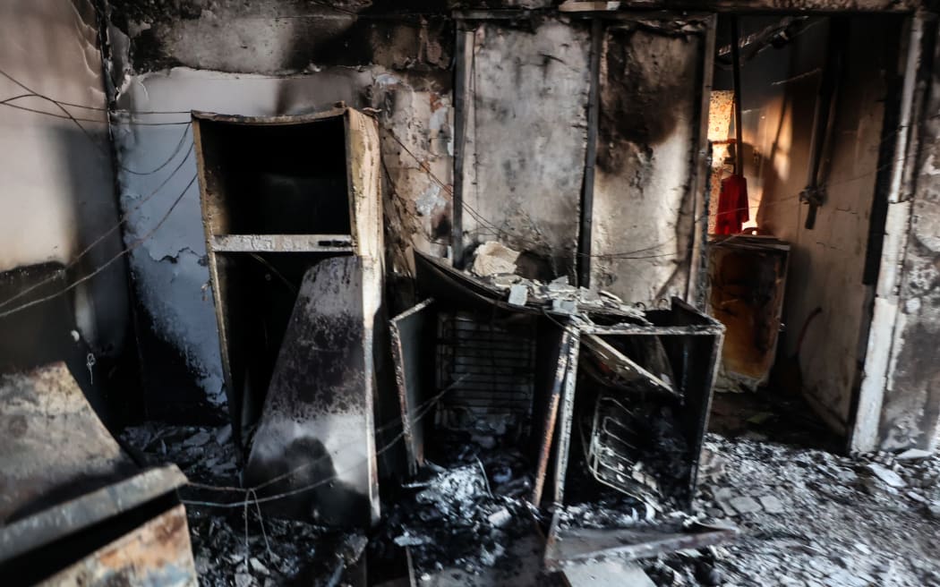 Charred debris and objects are scattered inside a building in kibbutz Alumim, following the October 7 attack by Hamas fighters, in southern Israel near the Gaza Strip on October 18, 2023. Thousands of people, both Israeli and Palestinians have died since October 7, 2023, after Palestinian Hamas militants based in the Gaza Strip, entered southern Israel in a surprise attack leading Israel to declare war on Hamas in Gaza on October 8. (Photo by GIL COHEN-MAGEN / AFP)