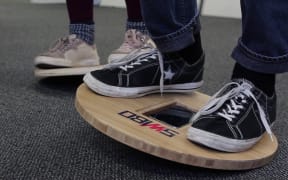 The mobile phone sitting the balance board works as a kind of joystick for the video game.