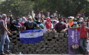 Students wait for riot police agents in a barricade close to Nicaragua's Technical College during protests against government's reforms in the Institute of Social Security