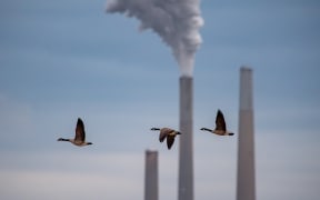 Pollution and steam rise from the stacks of the Miami Fort Power Station, which is situated along the Ohio River near Cincinnati, Ohio, on 2 November, 2025.