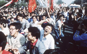 File - Chinese students shout after breaking through a police blockade during a pro-democracy march to Tiananmen Square, Beijing, May 4, 1989. Colleges and universities have long been protected places for free expression without pressure or punishment. But protests over Israel's conduct of the war in Gaza in its hunt for Hamas after the Oct. 7 massacre has tested that ideal around the world. The crackdowns are reviving memories of student-led protests during the American civil rights movement, the Vietnam War and the pro-democracy demonstrations in Beijing’s Tiananmen Square. (AP Photo/S. Mikami, File)