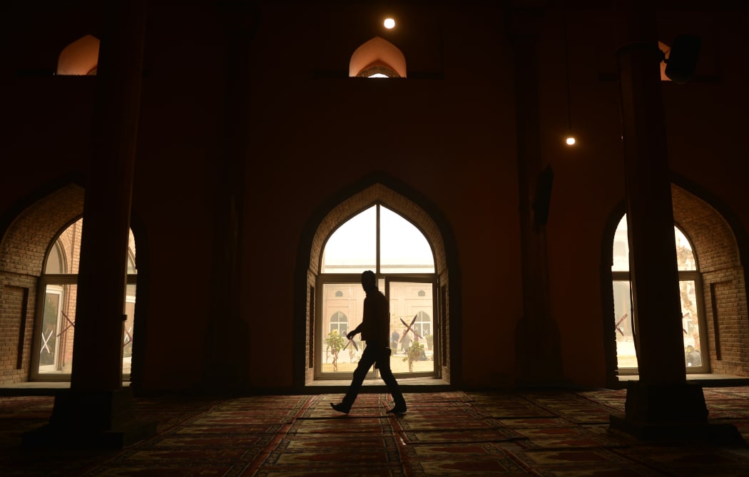 Kashmiri muslim walks by a window during the Friday prayer in Jamia Masjid in downtown Srinagar on November 25, 2016. 
TAUSEEF MUSTAFA / AFP