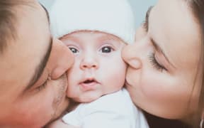 Young mother and father with newborn