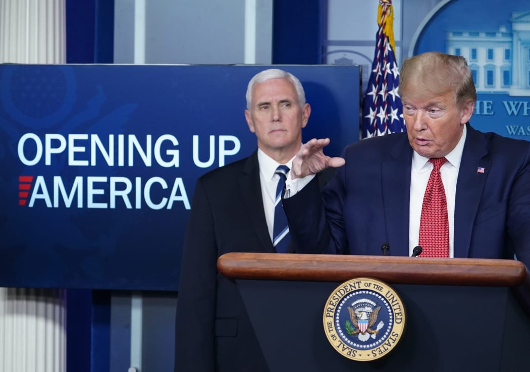 US President Donald Trump flanked by US Vice President Mike Pence, speaks during the daily briefing on the novel coronavirus, which causes COVID-19, in the Brady Briefing Room of the White House on April 16, 2020, in Washington, DC. (Photo by MANDEL NGAN / AFP)