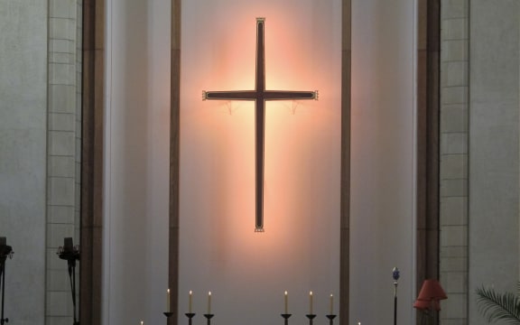 Cross on wall behind cathedral altar