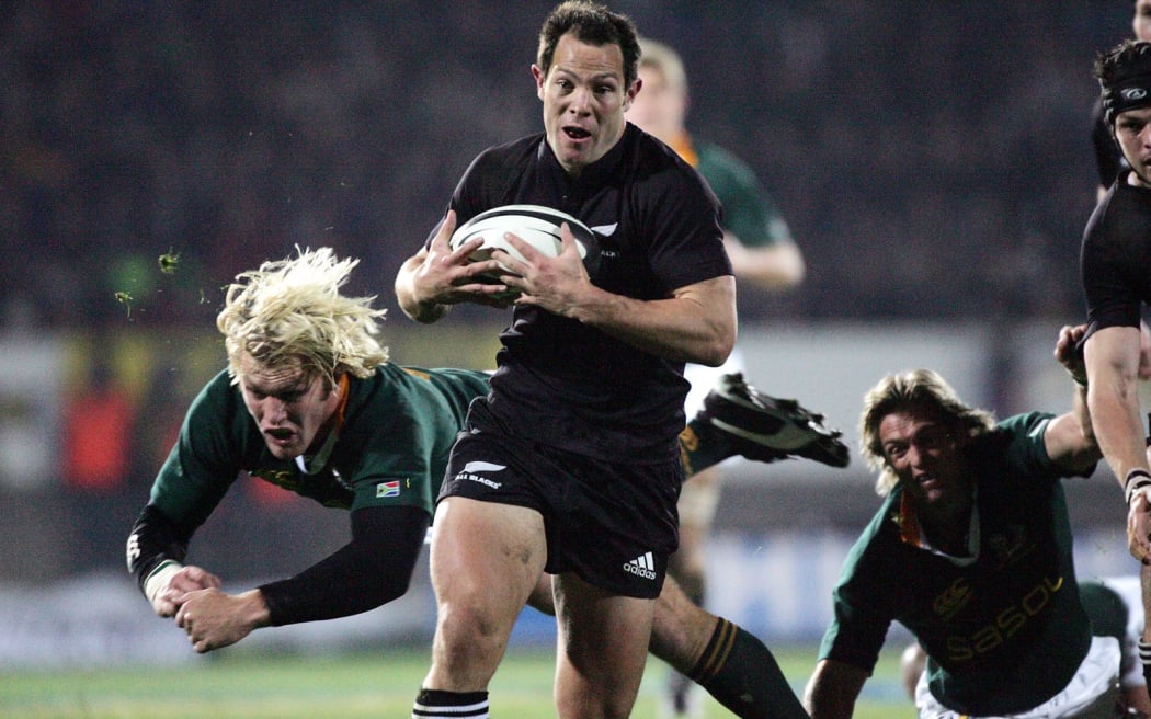 Leon Macdonald slips past Schalk Burger for a try during the Tri Nations match againt South Africa at Carisbrook in 2005.