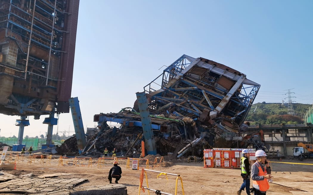 This handout photo taken on November 6, 2025 and released by the Ulsan Fire Department via Yonhap shows a 60 meter-high boiler tower (back C) at the Korea East-West Power Corporation after it collapsed in the southeastern city of Ulsan. At least seven people were trapped after a power plant structure collapsed on South Korea's east coast, the National Fire Agency said on November 6. (Photo by Handout / ULSAN FIRE DEPARTMENT / AFP) / - South Korea OUT / - SOUTH KOREA OUT /  - SOUTH KOREA OUT / RESTRICTED TO EDITORIAL USE - MANDATORY CREDIT "AFP PHOTO / ULSAN FIRE DEPARTMENT VIA YONHAP" - HANDOUT - NO MARKETING NO ADVERTISING CAMPAIGNS - DISTRIBUTED AS A SERVICE TO CLIENTS