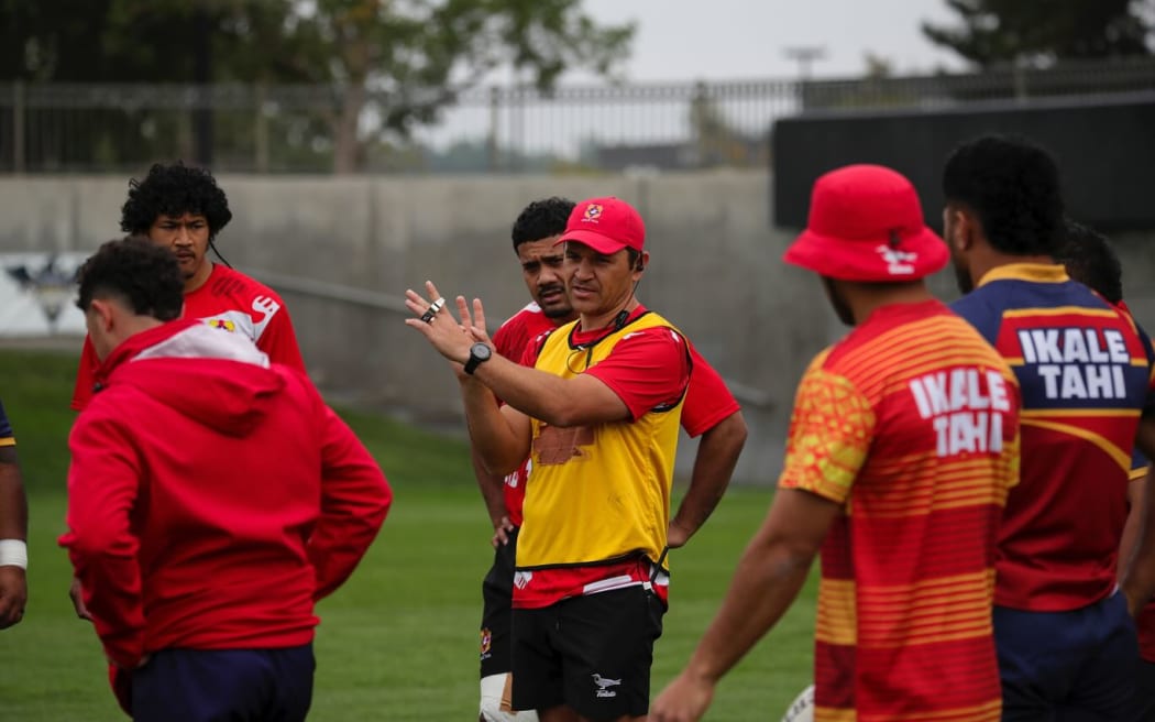 Assistant coach Daniel Halangahu (yellow vest in the middle) shares a move with 'Ikale Tahi players in Denver, ahead of their PNC semi-final clash against Japan on Monday morning.