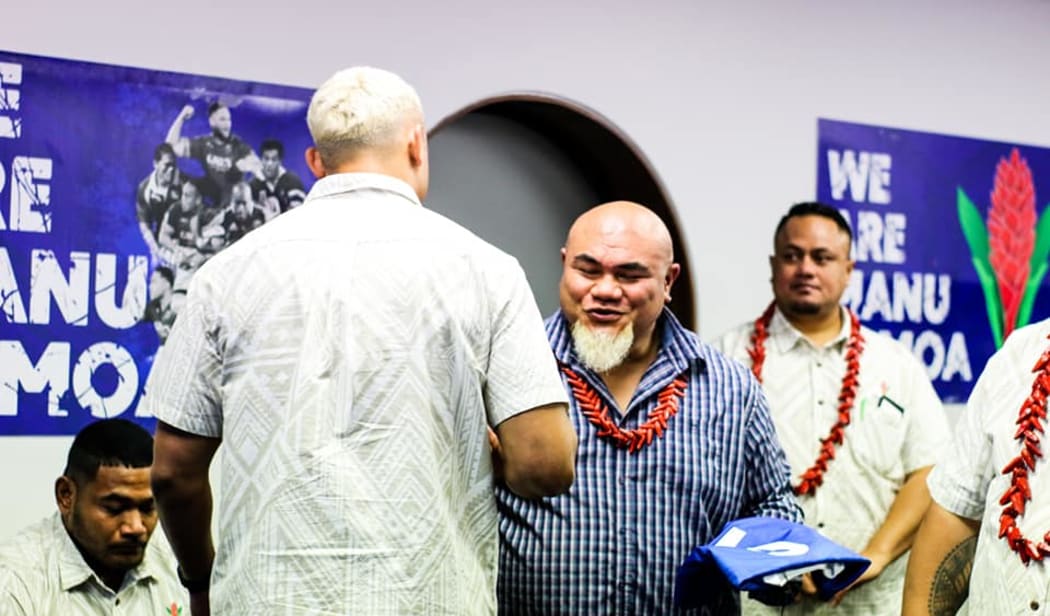 Former boxing champion, David Tua, presents Manu Samoa players with their jerseys ahead of the test match against Tonga.