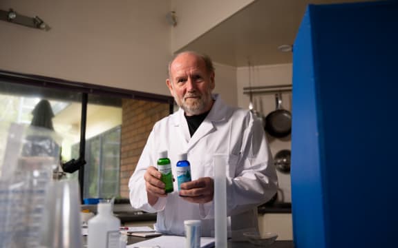 Forensic scientist Dr Ian Calhaem holding sodium chlorite and hydrochloric acid.