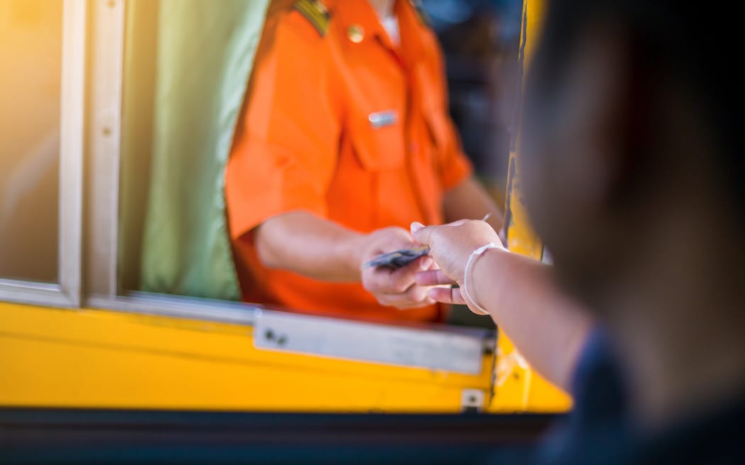 Driver pay for the expressway. Man pays money to a cashier for a toll road toll gate motorway entrance.