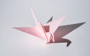 Pink paper origami bird