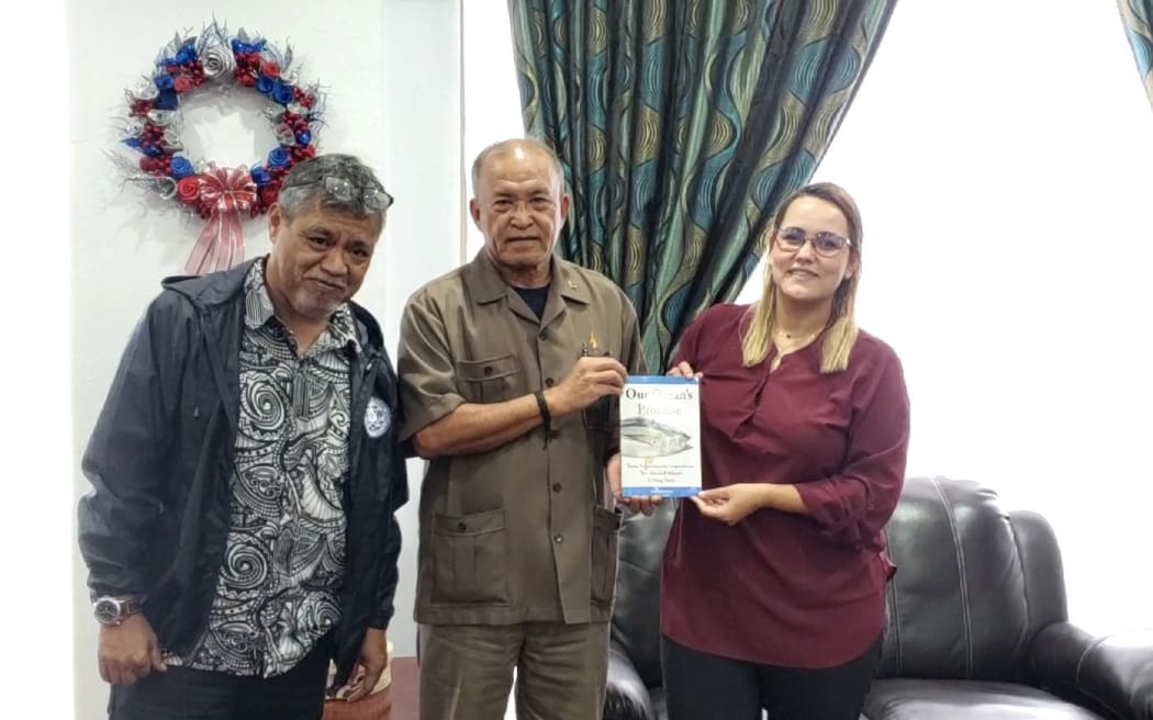 Marshall Islands President David Kabua (center) receives the new book, Our Ocean's Promise: From Aspirations to Inspirations — The Marshall Islands Fishing Story, from Marine Resources Authority Director Glen Joseph (left) and Environmental Protection Authority General Manager Moriana Phillip.