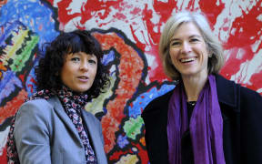 French researcher in Microbiology, Genetics and Biochemistry Emmanuelle Charpentier (L) and US professor of Chemistry Jennifer Doudna posing beside a painting made by children of the genoma at the San Francisco park