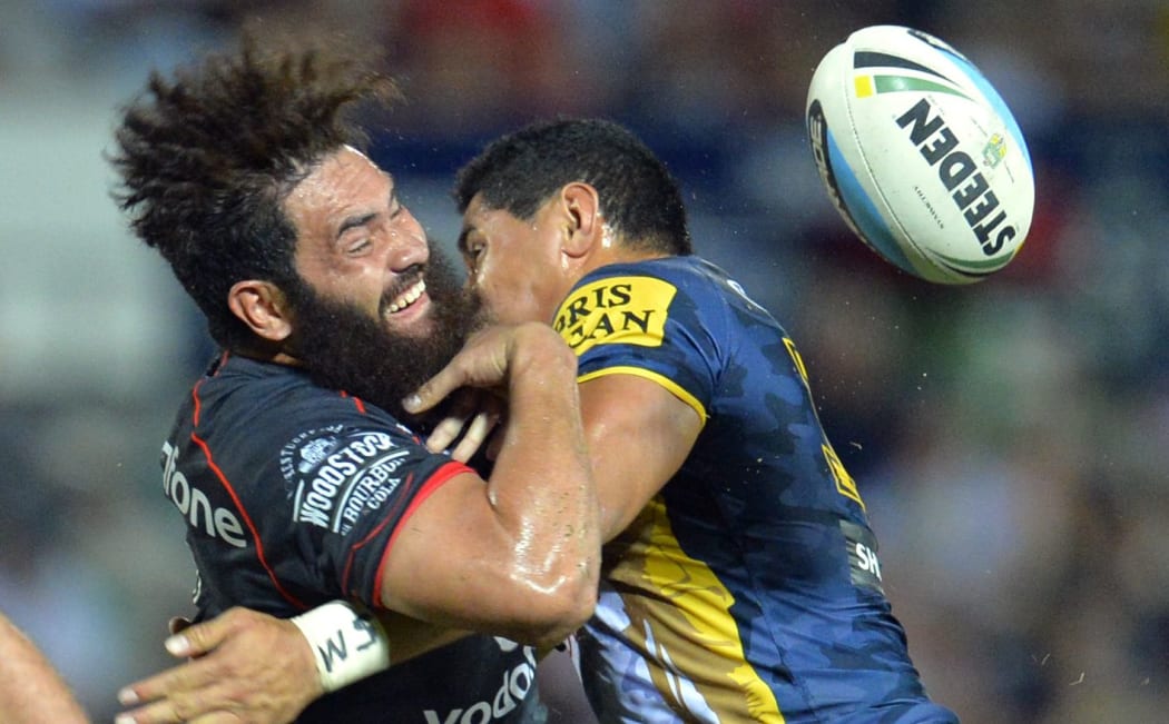 The Warriors' Konrad Hurrell loses the ball as the Cowboy's Jason Taumalolo makes a tackle.