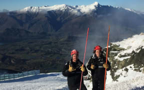 Coronet peak staff members Jake Reilly and Lucy Ruck help with snowmaking duties.